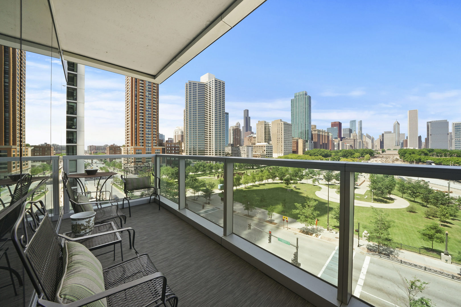 1201 South Prairie Avenue, Unit 601 Chicago, IL 60605 - Photo 4 of 52 a view of a city from a balcony with furniture