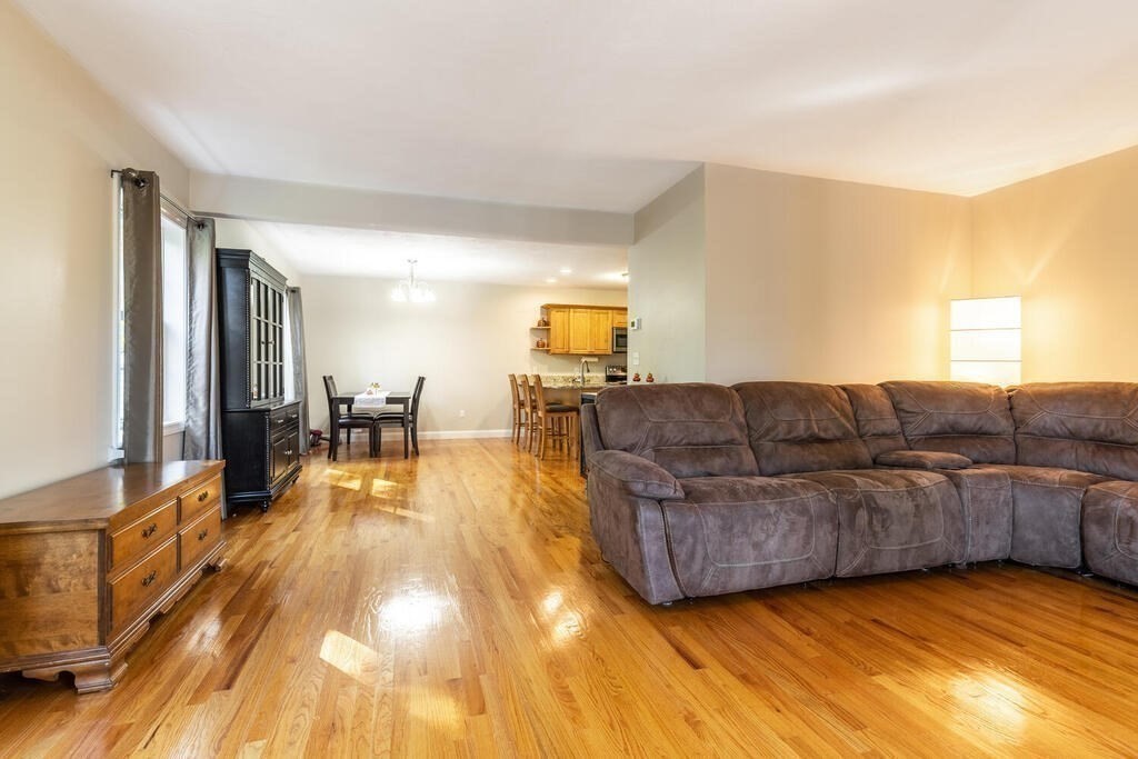 193 Scotland Road, Unit A Newbury, MA 01951 - Photo 8 of 29 a living room with couches and kitchen view with wooden floor