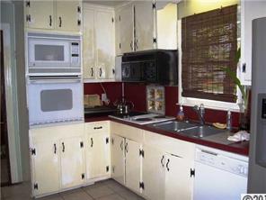 2703 South Point Road Belmont, NC 28012 - Photo 2 of 15 a kitchen with granite countertop white cabinets and black appliances