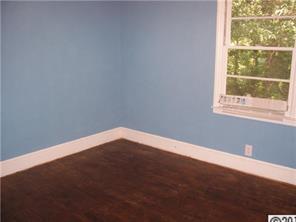 2703 South Point Road Belmont, NC 28012 - Photo 10 of 15 an empty room with wooden floor and windows