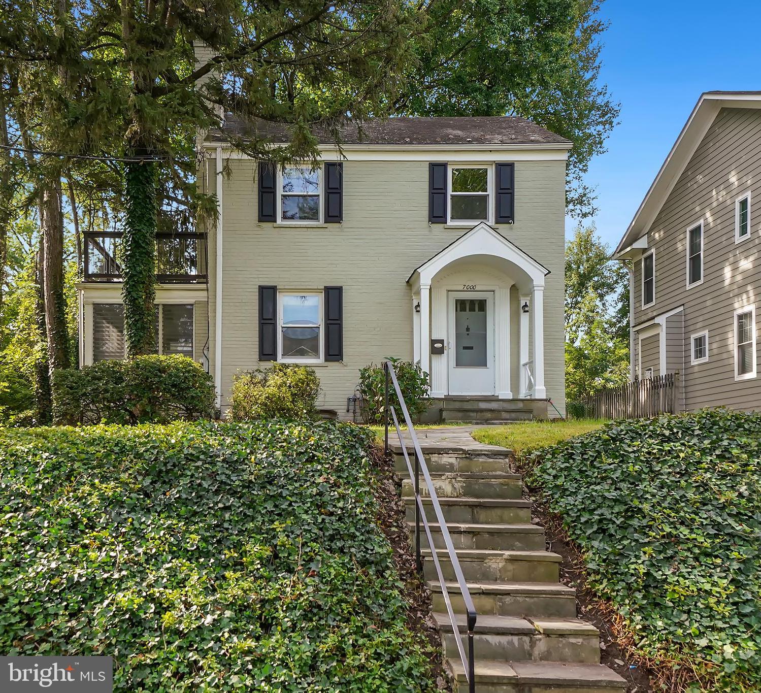 7000 Exeter Road Bethesda, MD 20814 - Photo 1 of 31 a front view of a house with a garden