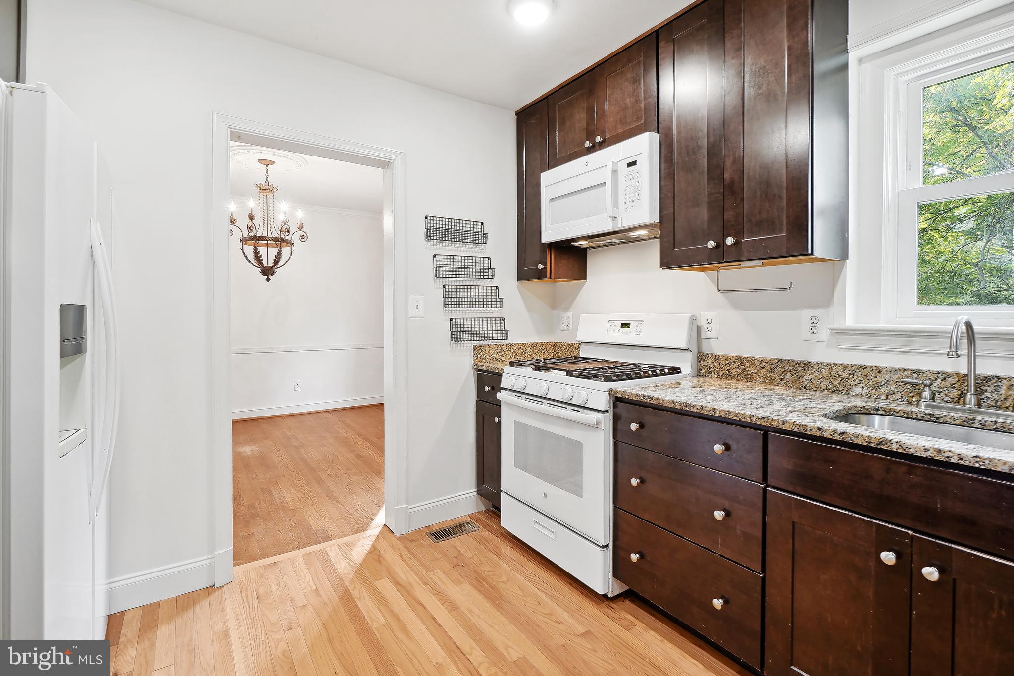 7000 Exeter Road Bethesda, MD 20814 - Photo 12 of 31 a spacious bathroom with a granite countertop sink and a mirror