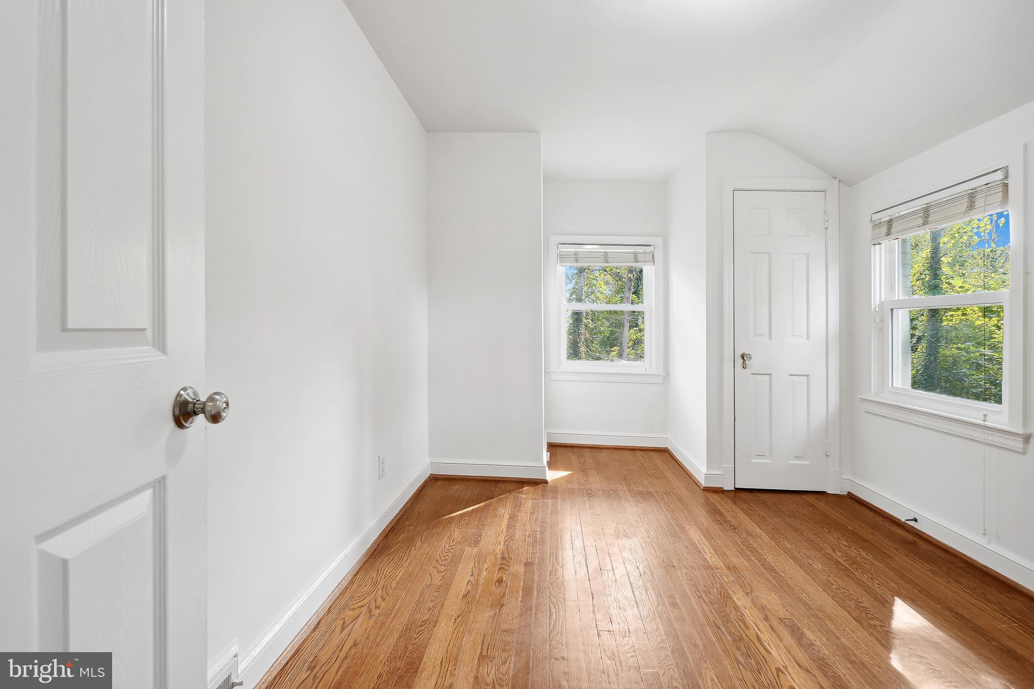7000 Exeter Road Bethesda, MD 20814 - Photo 17 of 31 an empty room with wooden floor and windows