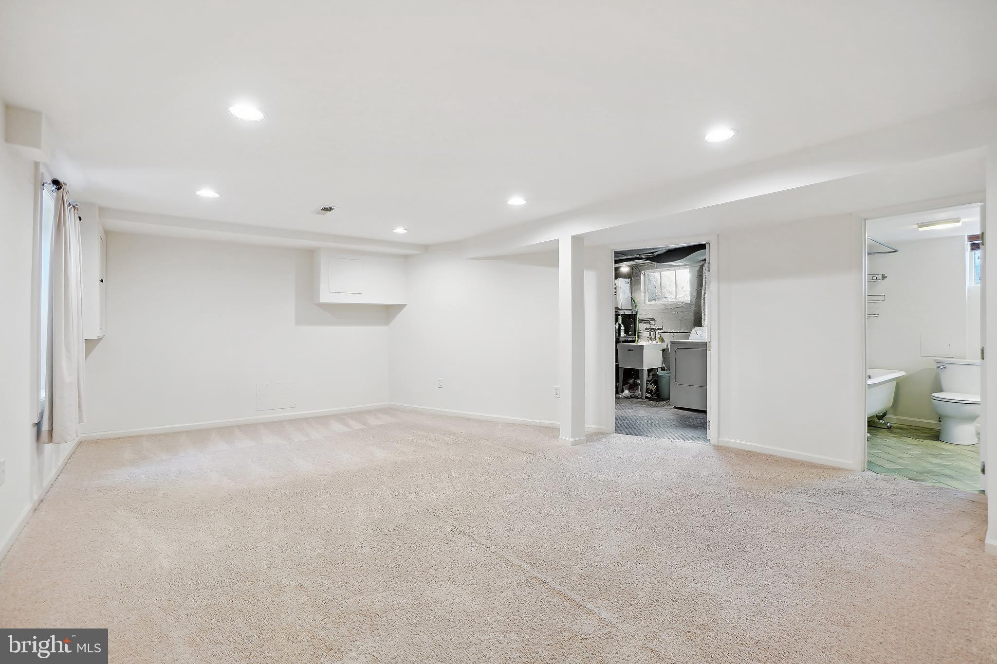 7000 Exeter Road Bethesda, MD 20814 - Photo 26 of 31 a view of an empty room with wooden floor and a kitchen