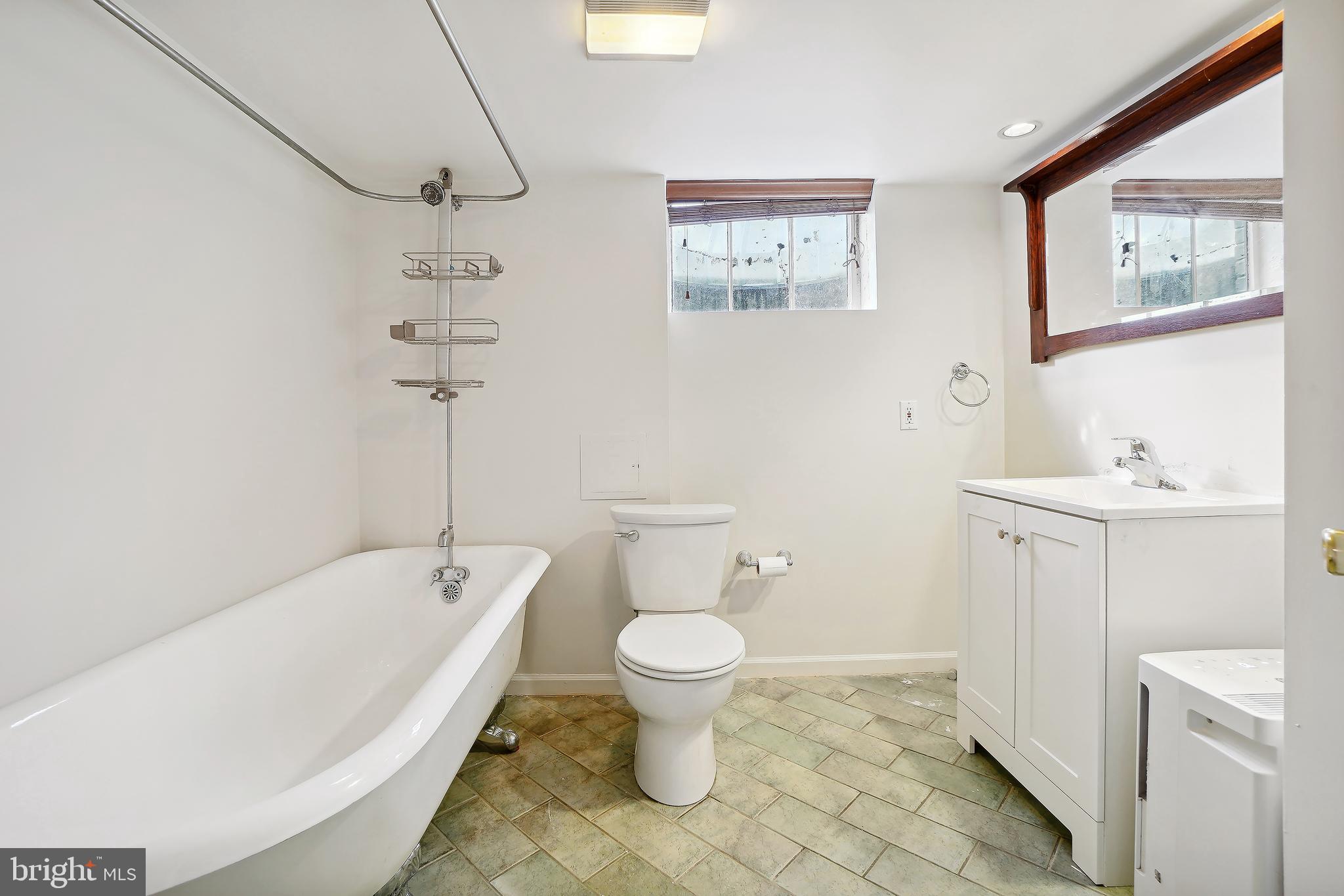 7000 Exeter Road Bethesda, MD 20814 - Photo 28 of 31 a bathroom with a sink a toilet and shower