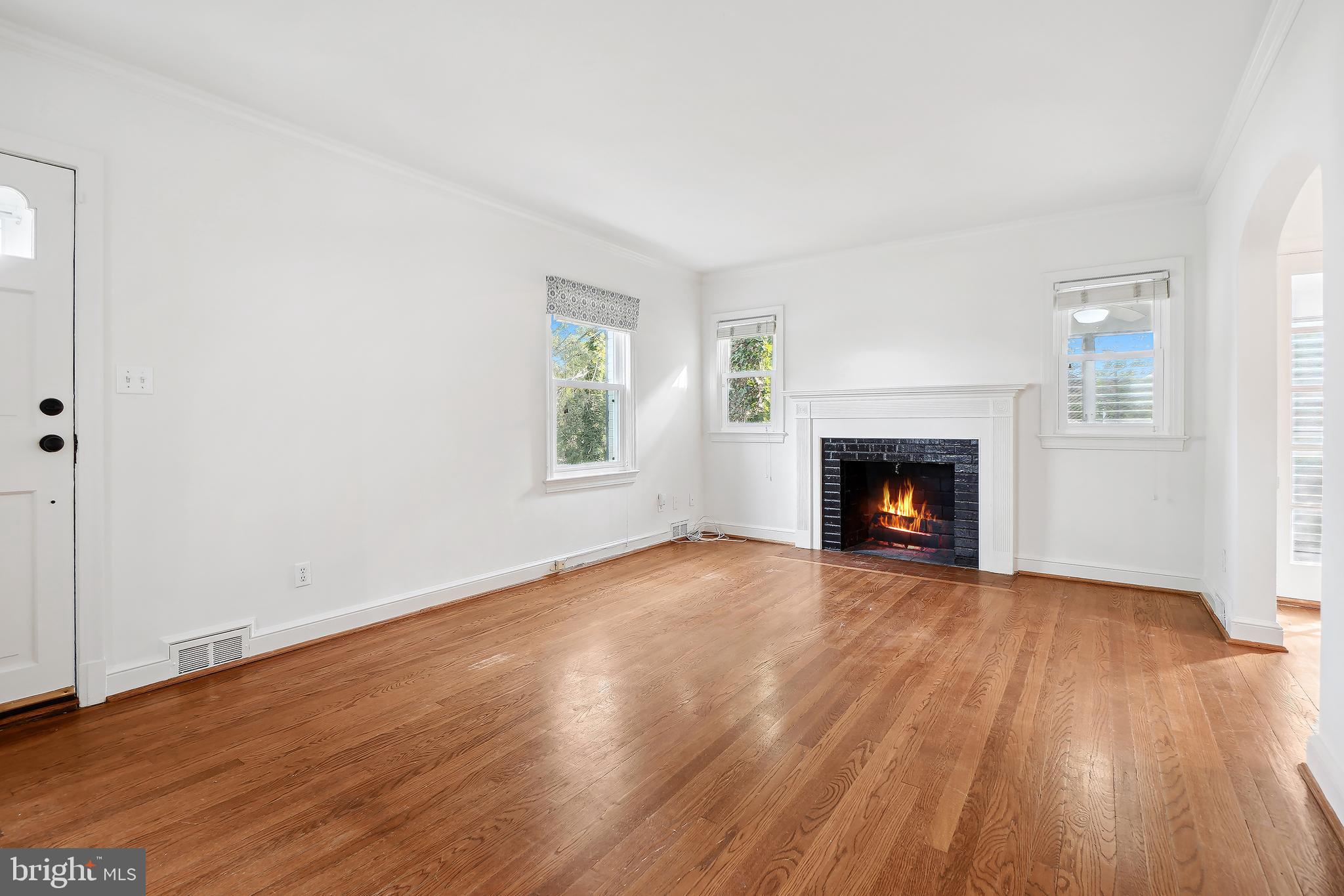 7000 Exeter Road Bethesda, MD 20814 - Photo 5 of 31 a view of empty room with wooden floor and fireplace
