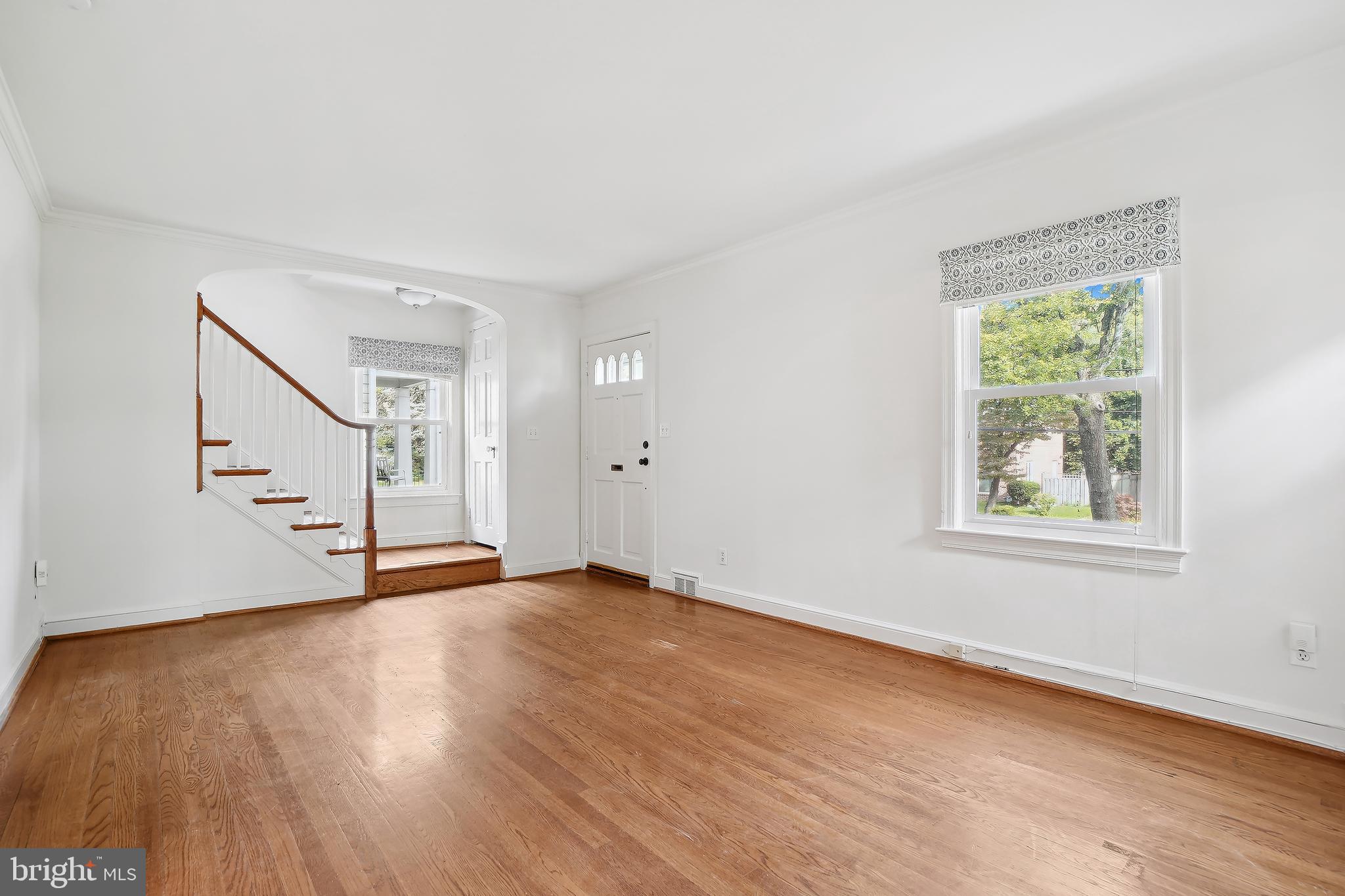 7000 Exeter Road Bethesda, MD 20814 - Photo 7 of 31 a view of an empty room with wooden floor and a window