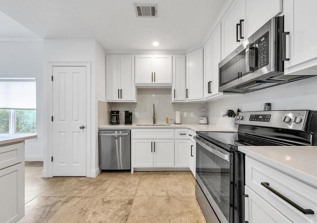 3880 East County Highway 30A, Unit 104 Santa Rosa Beach, FL 32459 - Photo 12 of 49 a kitchen with stainless steel appliances granite countertop a stove and a sink