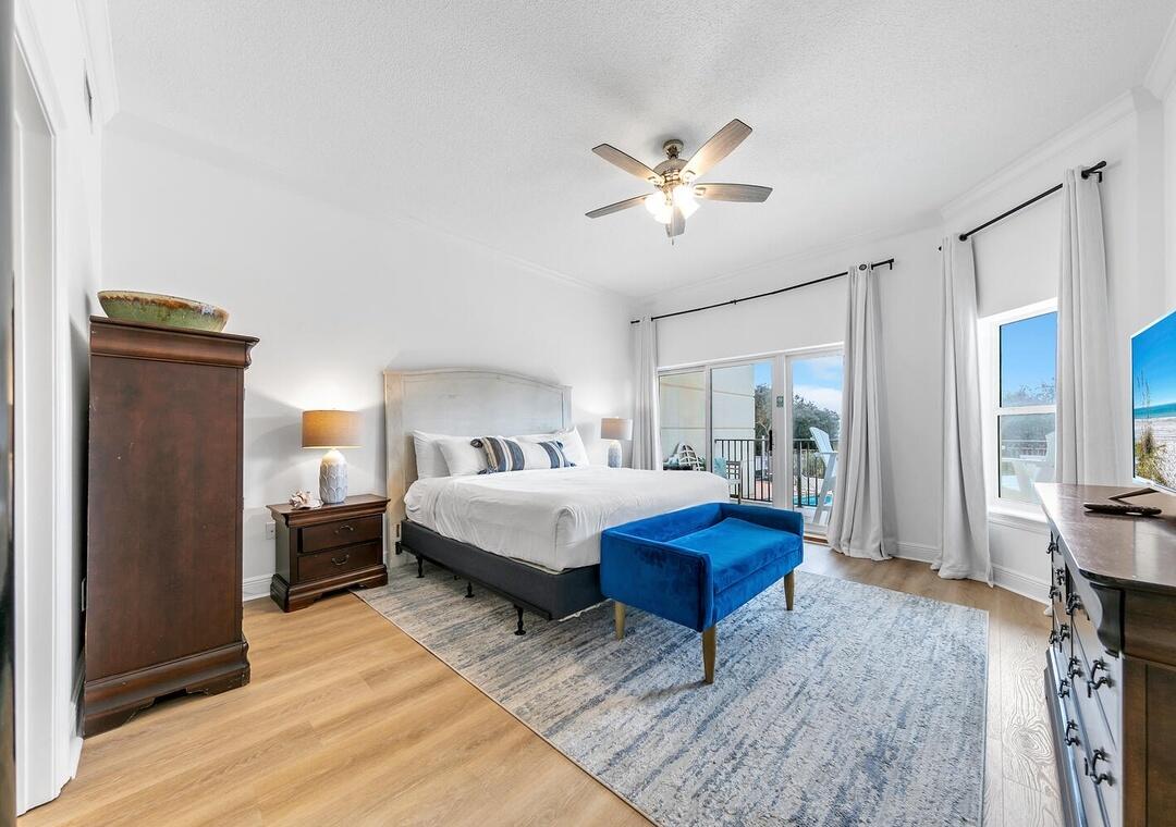3880 East County Highway 30A, Unit 104 Santa Rosa Beach, FL 32459 - Photo 15 of 49 a bedroom with a bed and a chandelier