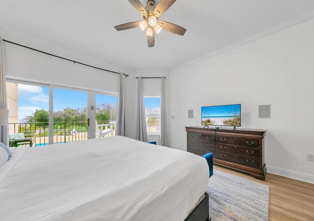 3880 East County Highway 30A, Unit 104 Santa Rosa Beach, FL 32459 - Photo 16 of 49 a bedroom with a bed and a chandelier