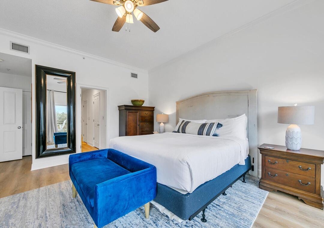 3880 East County Highway 30A, Unit 104 Santa Rosa Beach, FL 32459 - Photo 18 of 49 a bedroom with a large bed and a chandelier