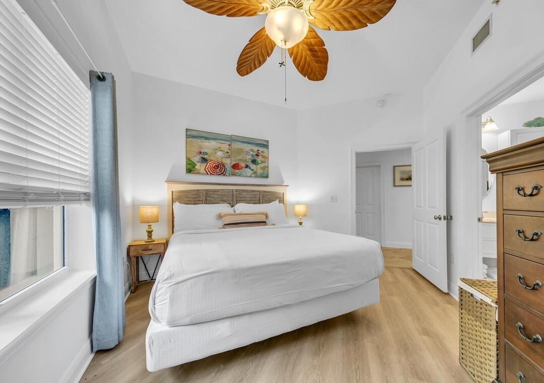 3880 East County Highway 30A, Unit 104 Santa Rosa Beach, FL 32459 - Photo 25 of 49 a bedroom with a bed and wooden floor