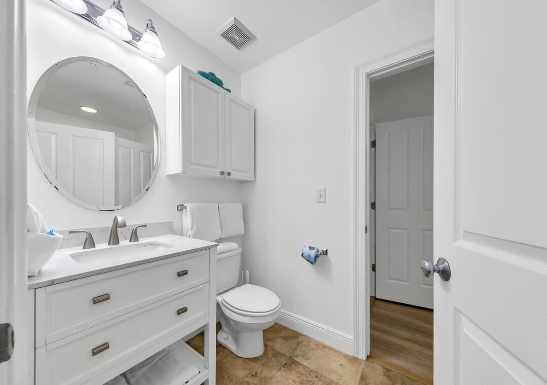 3880 East County Highway 30A, Unit 104 Santa Rosa Beach, FL 32459 - Photo 26 of 49 a spacious bathroom with a toilet a sink and mirror
