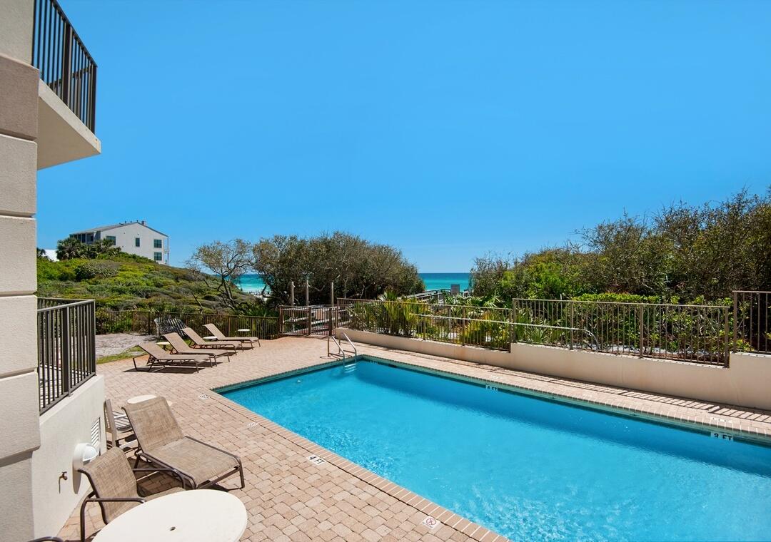 3880 East County Highway 30A, Unit 104 Santa Rosa Beach, FL 32459 - Photo 3 of 49 a view of a swimming pool with outdoor seating and plants