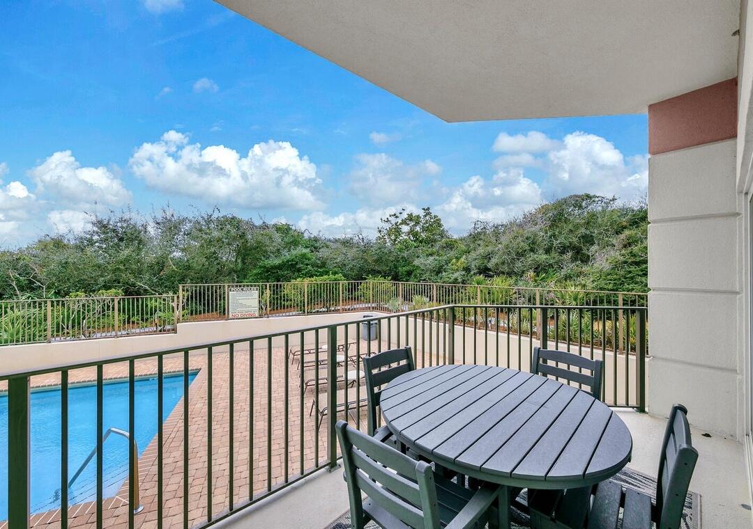 3880 East County Highway 30A, Unit 104 Santa Rosa Beach, FL 32459 - Photo 40 of 49 a view of a balcony with wooden floor and outdoor seating