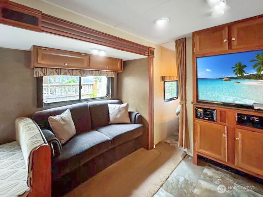 47 Wilderness Way Maple Falls, WA 98266 - Photo 12 of 40 a living room with furniture and a flat screen tv