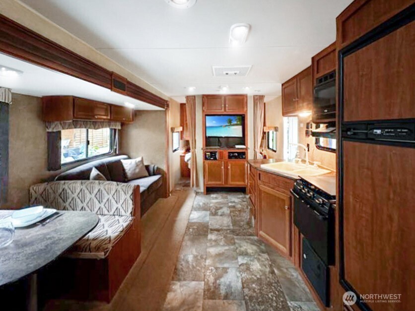 47 Wilderness Way Maple Falls, WA 98266 - Photo 16 of 40 a large kitchen with granite countertop lots of counter top space a sink and stainless steel appliances