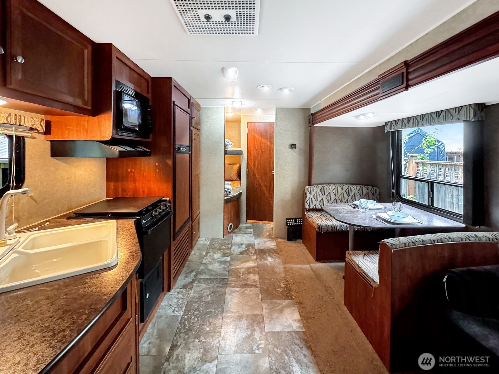 47 Wilderness Way Maple Falls, WA 98266 - Photo 17 of 40 a kitchen with stainless steel appliances granite countertop a stove a sink and a microwave