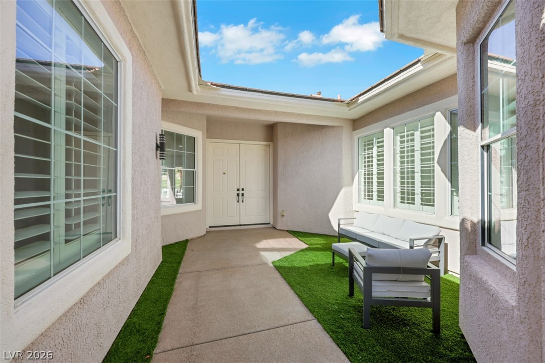 5015 Rivedro Street Las Vegas, NV 89135 - Photo 56 of 91 A welcoming front entry features an inviting path flanked by neat artificial turf, leading to elegant double doors.