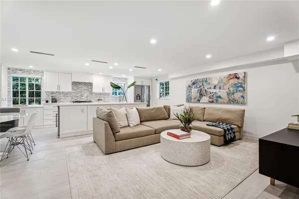 a living room with furniture and a painting