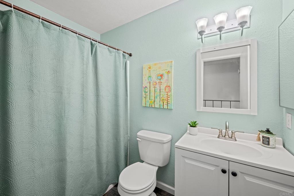 10323 Restful Court Santee, CA 92071 - Photo 11 of 30 a bathroom with a sink a toilet and a mirror