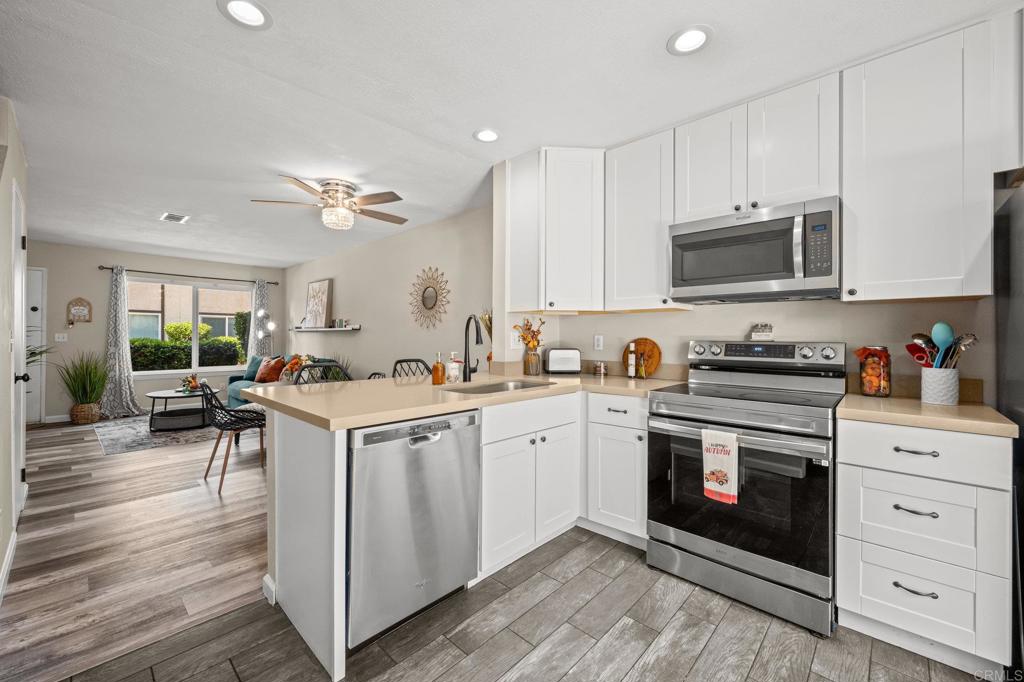 10323 Restful Court Santee, CA 92071 - Photo 7 of 30 a kitchen with a stove a sink and a refrigerator
