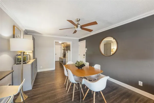 a dining room with furniture and wooden floor