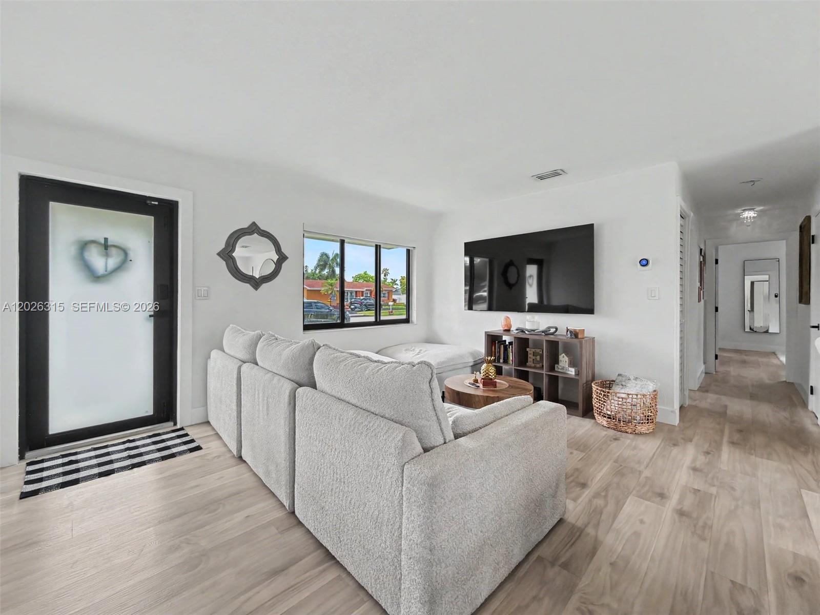 10762 Southwest 145th Street Miami, FL 33176 - Photo 19 of 28 a living room with furniture and a flat screen tv