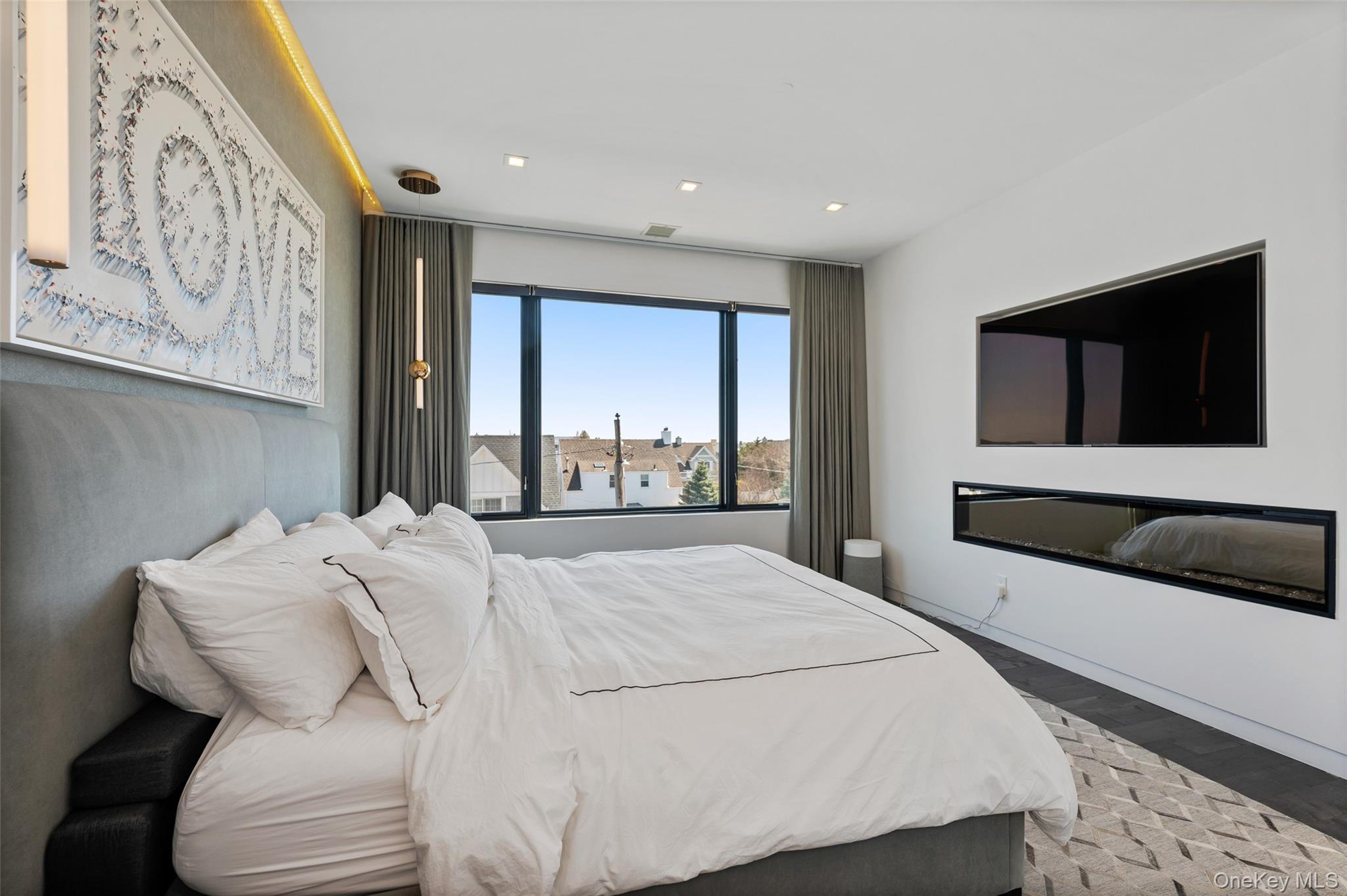 46 Nantwick Street Lido Beach, NY 11561 - Photo 18 of 50 a bedroom with a large bed and a flat tv screen on dresser