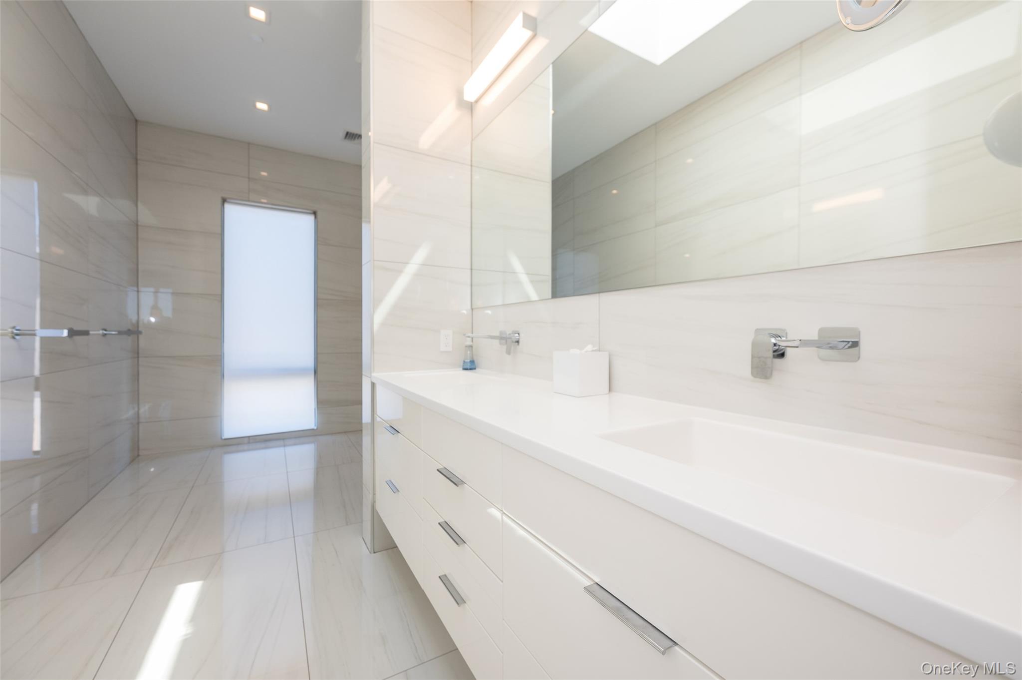 46 Nantwick Street Lido Beach, NY 11561 - Photo 19 of 50 a bathroom with a double vanity sink a toilet and shower