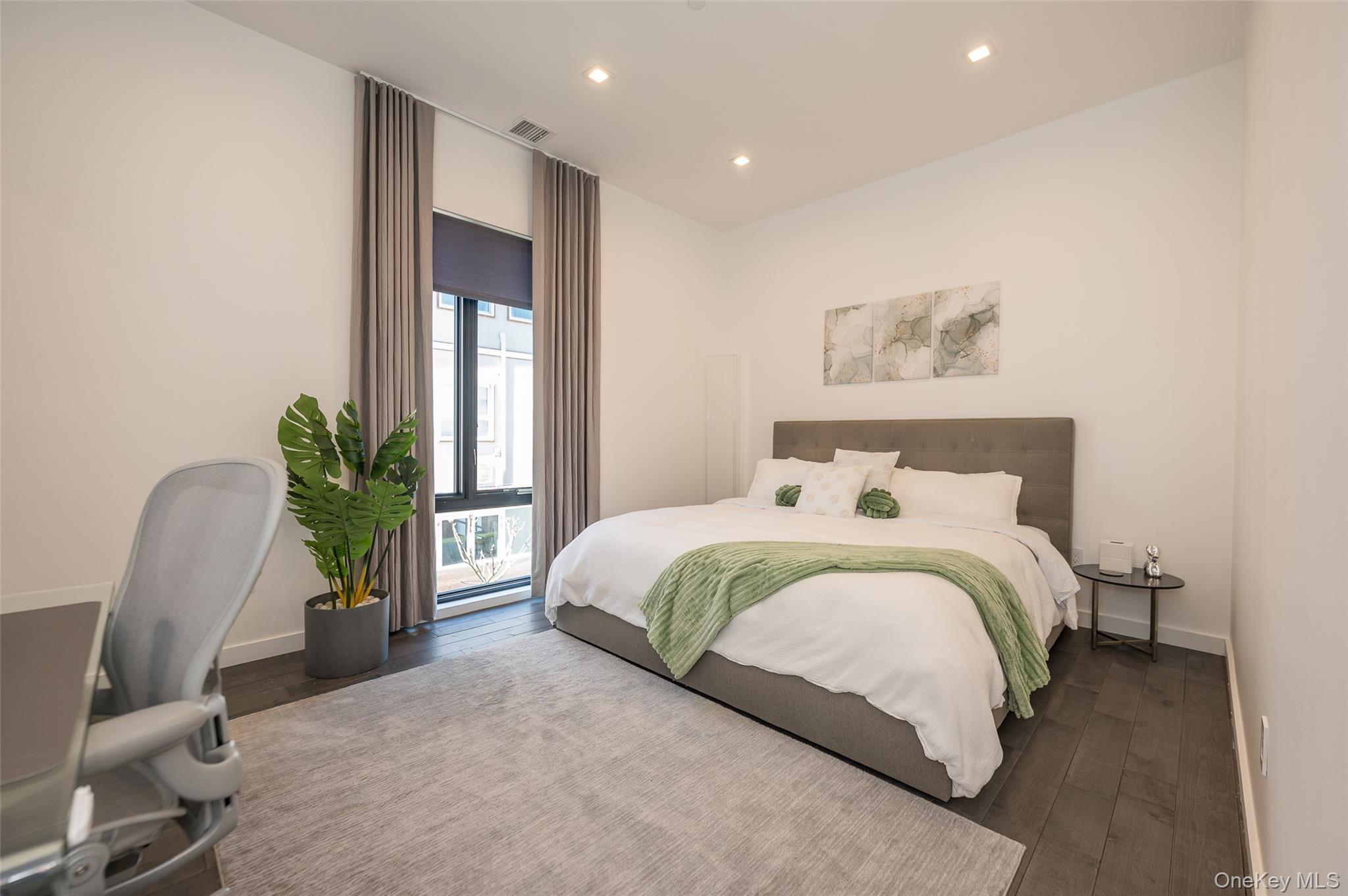 46 Nantwick Street Lido Beach, NY 11561 - Photo 31 of 50 a bedroom with a bed and a potted plant