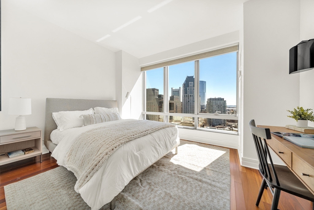 1 Avery Street, Unit 24D Boston, MA 02111 - Photo 13 of 16 a large bedroom with a bed and glass window