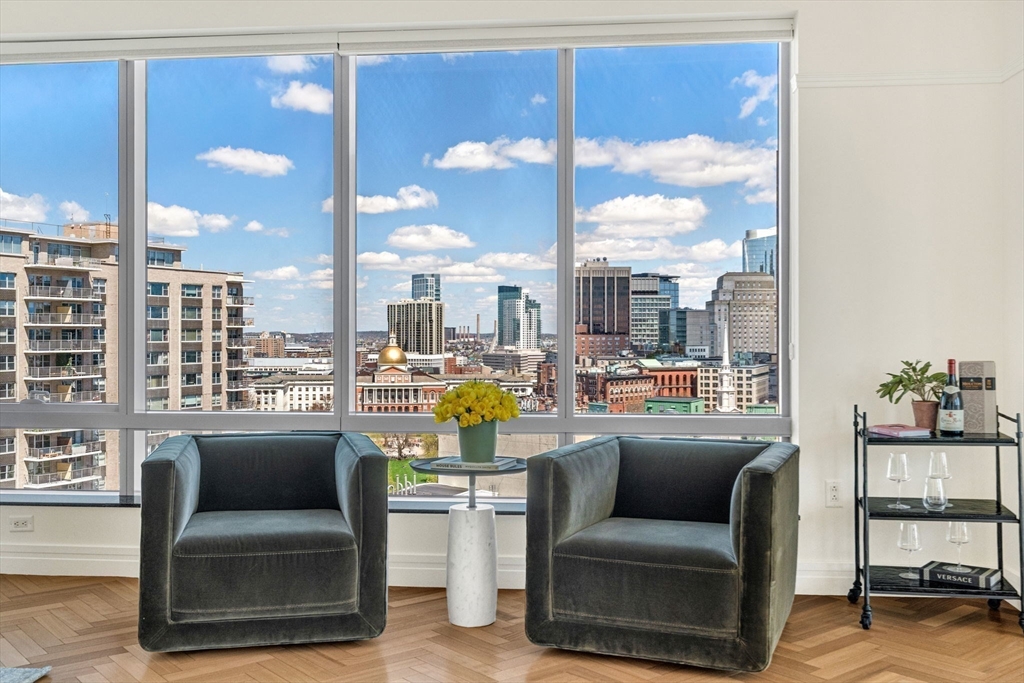 1 Avery Street, Unit 24D Boston, MA 02111 - Photo 6 of 16 a living room with furniture and a floor to ceiling window