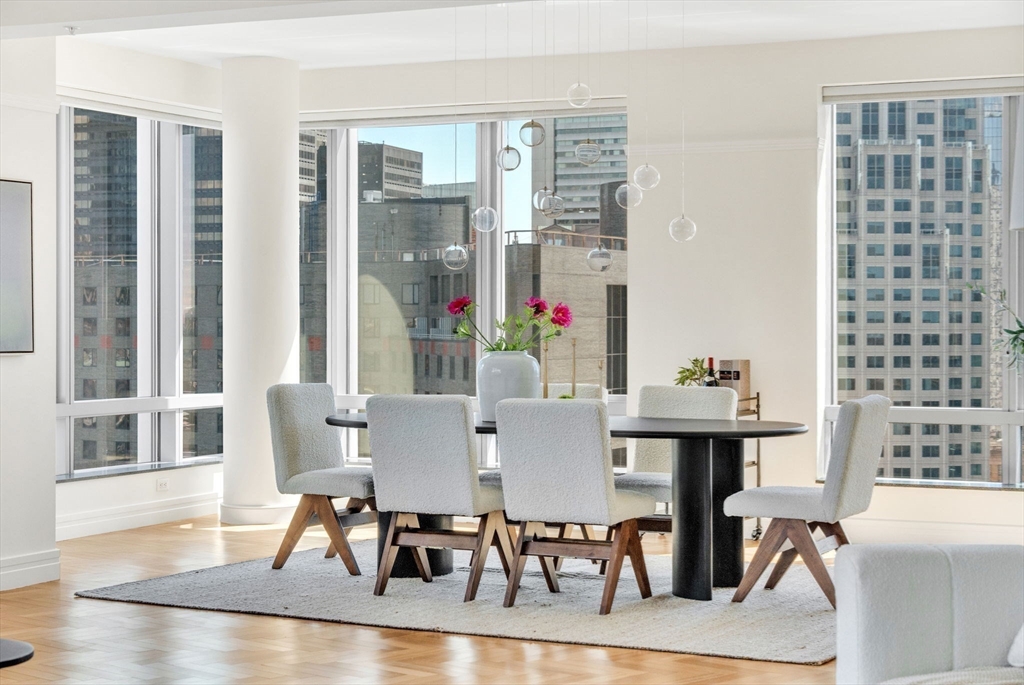 1 Avery Street, Unit 24D Boston, MA 02111 - Photo 7 of 16 a view of a dining room with furniture and wooden floor