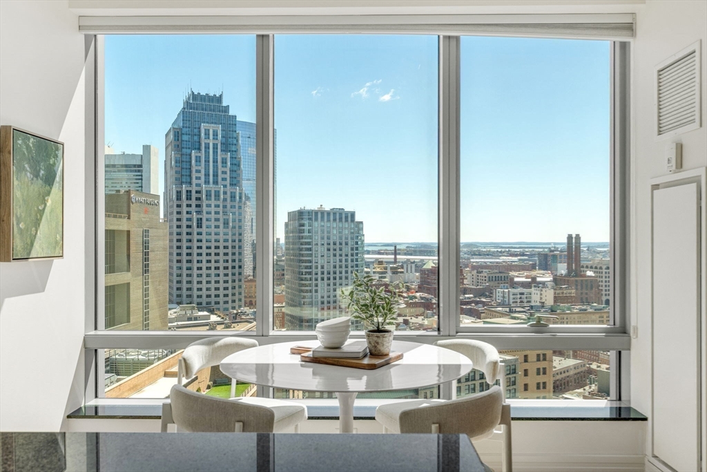 1 Avery Street, Unit 24D Boston, MA 02111 - Photo 9 of 16 a living room with furniture and a floor to ceiling window