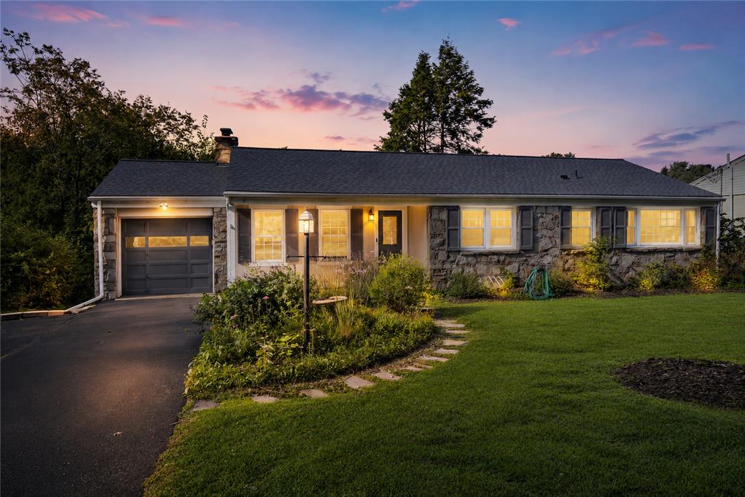 205 Bridle Path Road Bethlehem, PA 18017 - Photo 2 of 31 A classic stone facade and landscaped front lawn create exceptional curb appeal at twilight.