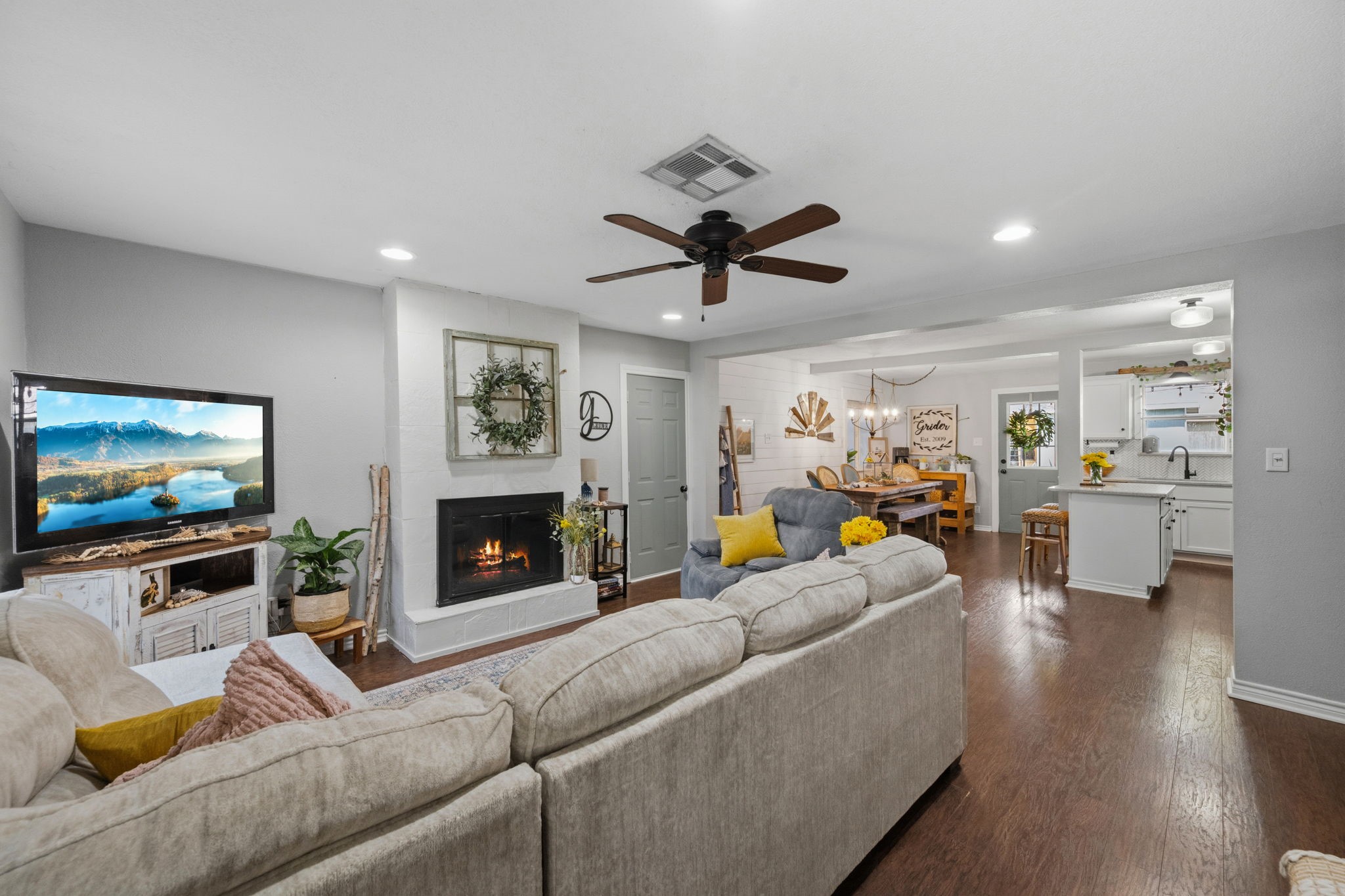 431 Corydon Drive Houston, TX 77336 - Photo 4 of 26 Step inside to an inviting open-concept layout, where the family room is anchored by a cozy fireplace and enhanced by recessed lighting and gleaming laminate floors.