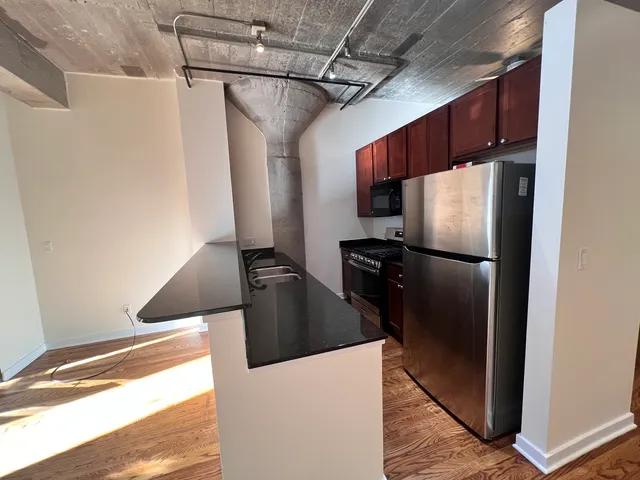 a kitchen with a refrigerator and a stove