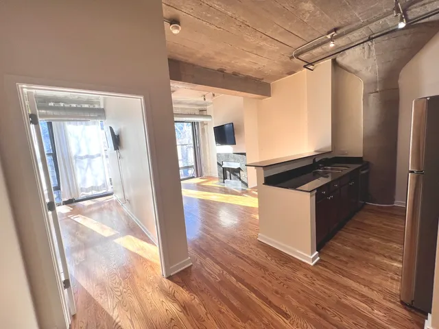 a kitchen with granite countertop a stove and a refrigerator