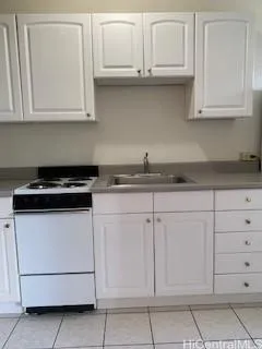 a kitchen with white cabinets and a stove