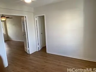 an empty room with wooden floor and closet