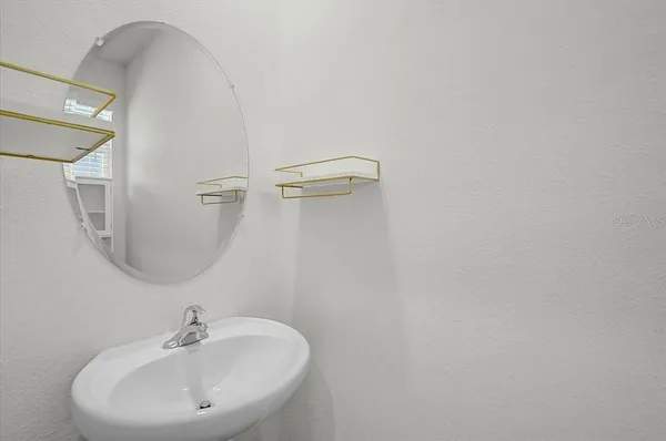 a bathroom with a sink a mirror and shower