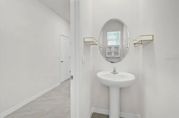 a bedroom with bed and a potted plant