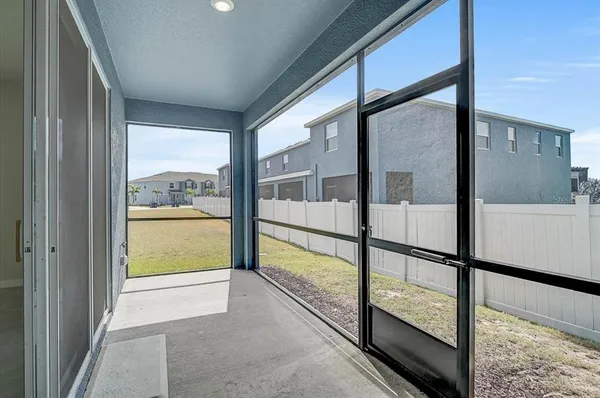 a view of a hallway with wooden floor and a living room