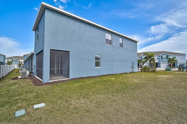 a view of a house with a yard and potted plants