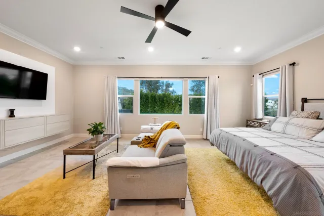 a spacious bedroom with a bed and a couch