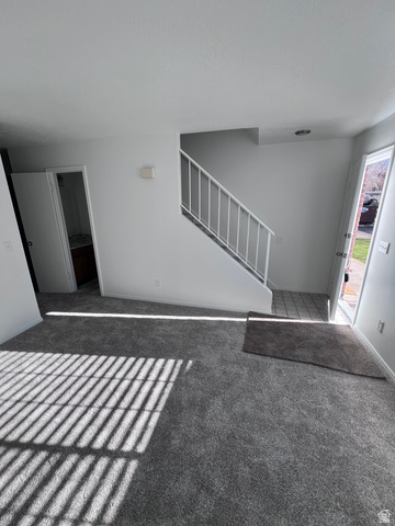 556 North Fairfield Road, Unit D4 Layton, UT 84041 - Photo 15 of 23 Unfurnished living room with stairs and carpet floors