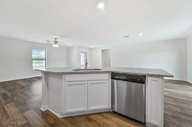 a kitchen with stainless steel appliances granite countertop a sink and cabinets