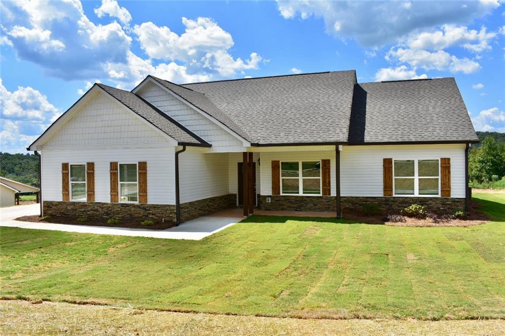 a front view of a house with garden