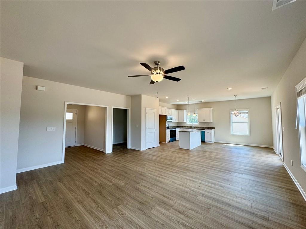 883 Dortch Road Eastanollee, GA 30538 - Photo 5 of 29 a view of an empty room with wooden floor and a ceiling fan
